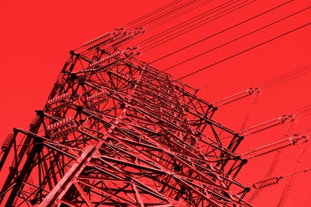 Close-up of high voltage pole on red background.