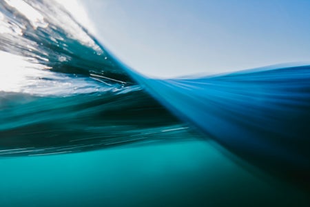 Vortex split view of blue ocean waters below and above surface