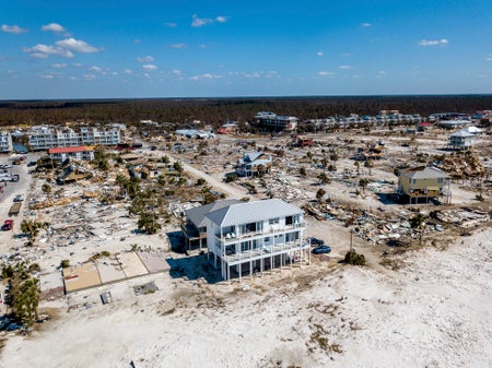 Home standing among other collapsed homes