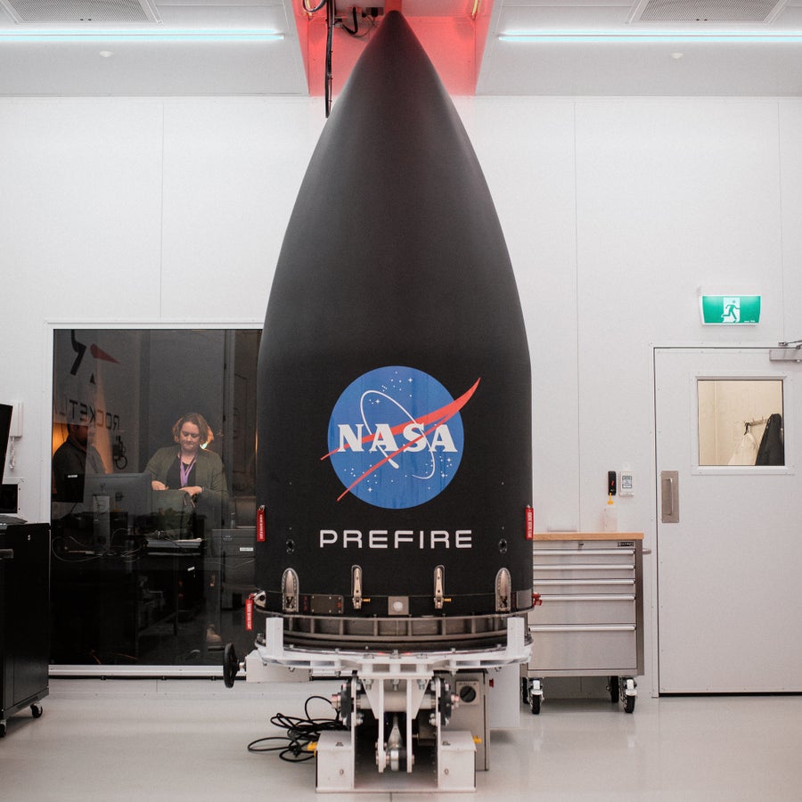 Inside a room at Rocket Lab's headquarters. In the room is the rocket payload for NASA's PREFIRE mission standing on a platform 