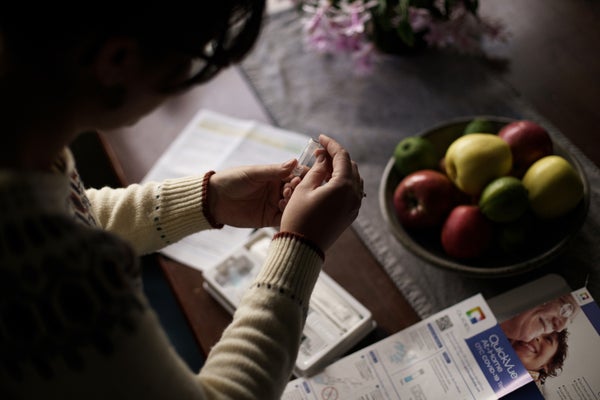 A person holds a COVID testing kit.