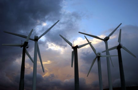 Night falls on giant windmills.