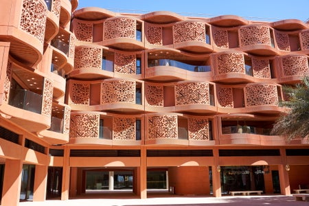 Four story building with a wavy terra cotta facade.