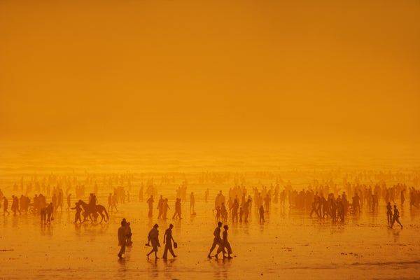 Crowded beach sunset silhouette