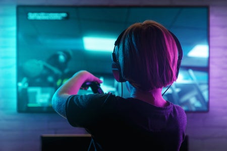 Young boy playing video game with headphones on