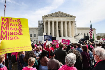 Demonstrators outside the US Supreme Court. Demonstrators are holding signs in support of legalized abortion and abortion pills