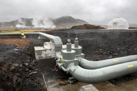 Industrial equipment in an inactive volcanic hilly landscape.